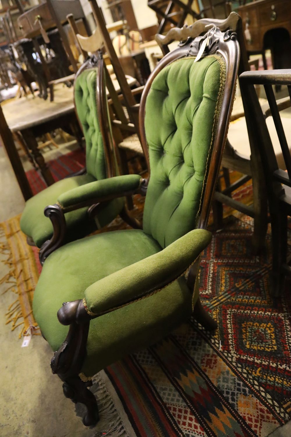 A pair of Victorian mahogany spoonback chairs, one with arms